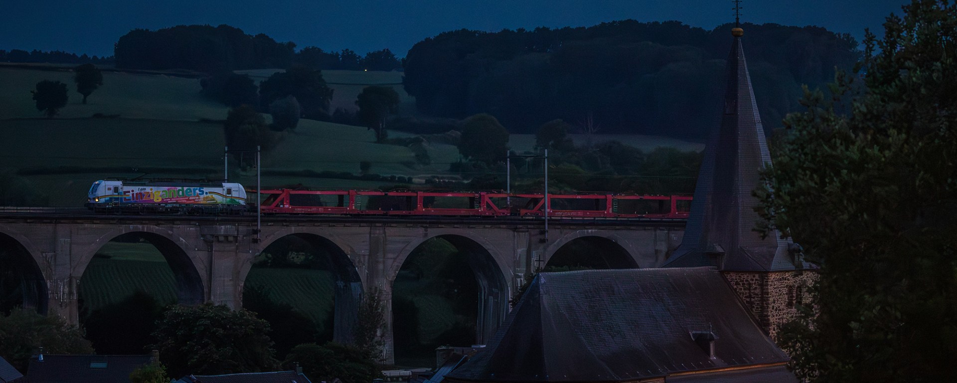 Car train on a bridge.