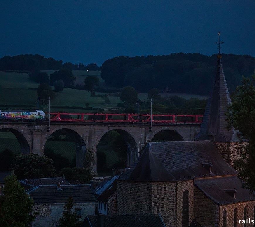 Car train on a bridge.