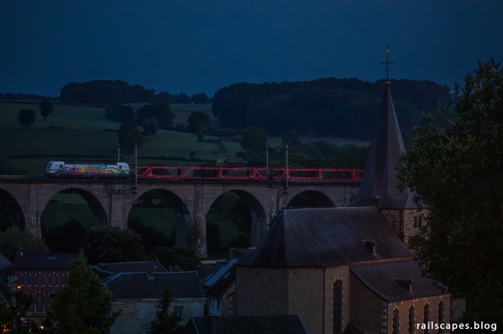 Car train on a bridge.